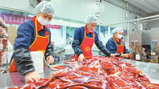 火锅底料生产车间，工人忙碌地封装。